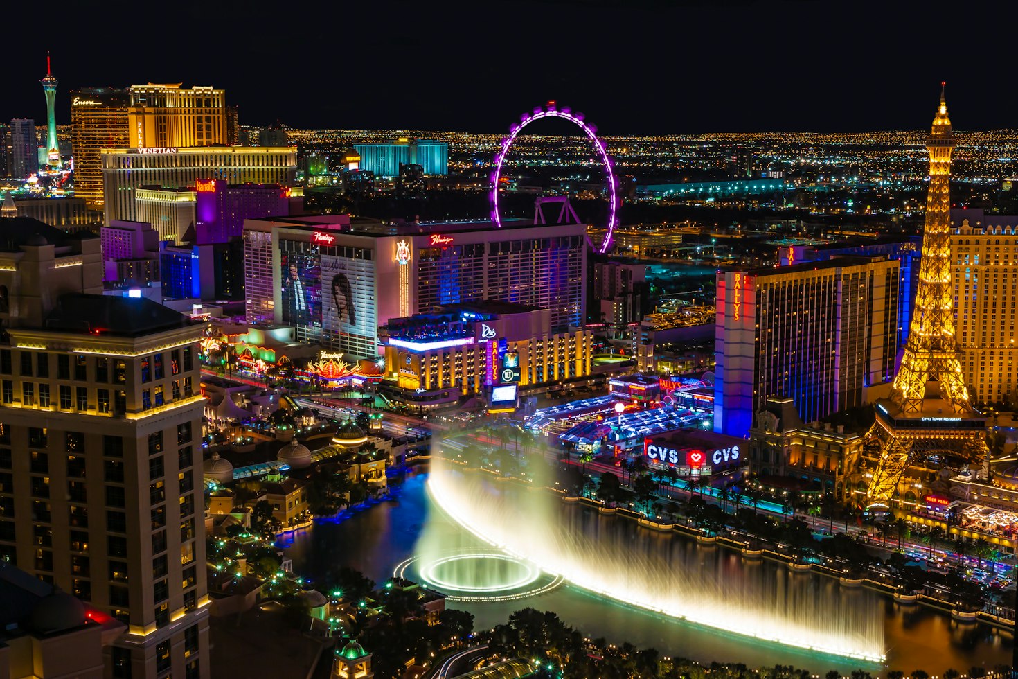 The Las Vegas Strip at night, with the High Roller, Paris tower and Bellagio fountains.